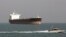 FILE - An Iranian Revolutionary Guard speedboat passes near an oil tanker, July 2, 2012. A collision late Saturday off the eastern coast of China left 30 Iranians missing.