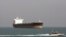 FILE - An Iranian Revolutionary Guard speedboat passes near an oil tanker, July 2, 2012.