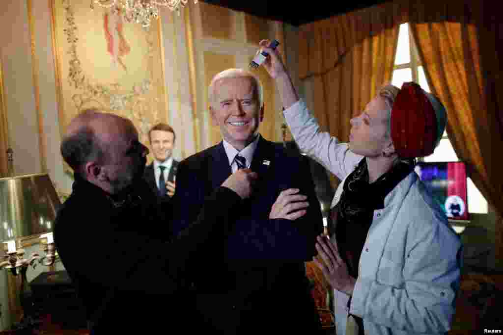 German sculptor Claus Velte and a gallery assistant retouch a waxwork of U.S. President Joe Biden at the Grevin museum, as it prepares to reopen to the public following the easing of coronavirus restrictions in Paris, France.