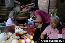 Volunteers recycle and restore used toys to donate them to vulnerable children as Christmas presents at the non-profit foundation Hospital de los Peluches, or Hospital of Stuffed Animals, in Caracas, Venezuela, Thursday, Dec. 5, 2024. (AP Photo/Ariana Cubillos)