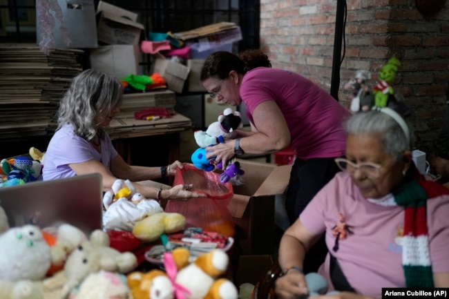 Volunteers recycle and restore used toys to donate them to vulnerable children as Christmas presents at the non-profit foundation Hospital de los Peluches, or Hospital of Stuffed Animals, in Caracas, Venezuela, Thursday, Dec. 5, 2024. (AP Photo/Ariana Cubillos)