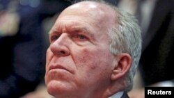 FILE - CIA Director John Brennan listens to remarks by President Barack Obama at the Director of National Intelligence Office to mark its 10th anniversary, in McLean, Virginia, April 24, 2015.