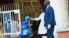 A student has her temperature checked, at the entrance of a private school in Harare, Zimbabwe, Sept. 14, 2020.