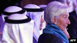 IMF chief Christine Lagarde, right, attends an international conference on Islamic finance, in Kuwait City, Nov. 11, 2015. She has urged Gulf countries, hurt by falling oil prices, to consider scaling back subsidies and levying taxes. 