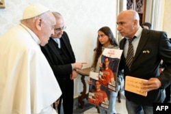 FILE— This photo taken and handout on April 8, 2024 by The Vatican Media shows Pope Francis during a meeting with relatives of Israeli hostages.