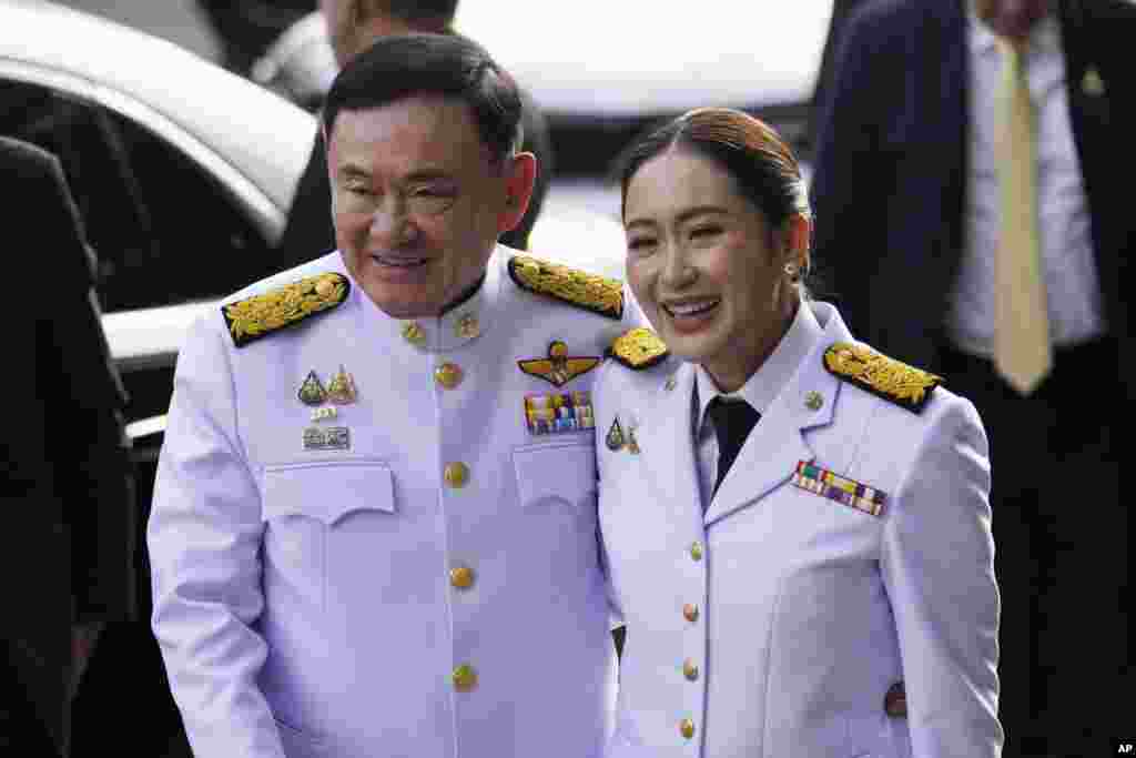 Thailand&#39;s former Prime Minister Thaksin Shinawatra, left, and his daughter and newly elected Prime Minister Paetongtarn Shinawatra arrive before the royal endorsement ceremony appointing Paetongtarn as Thailand&#39;s new prime minister at Pheu Thai party headquarters in Bangkok