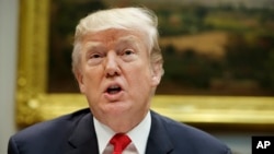 FILE - President Donald Trump speaks before hosting a lunch with Senate Republicans in the Roosevelt Room of the White House, Dec. 5, 2017, in Washington.