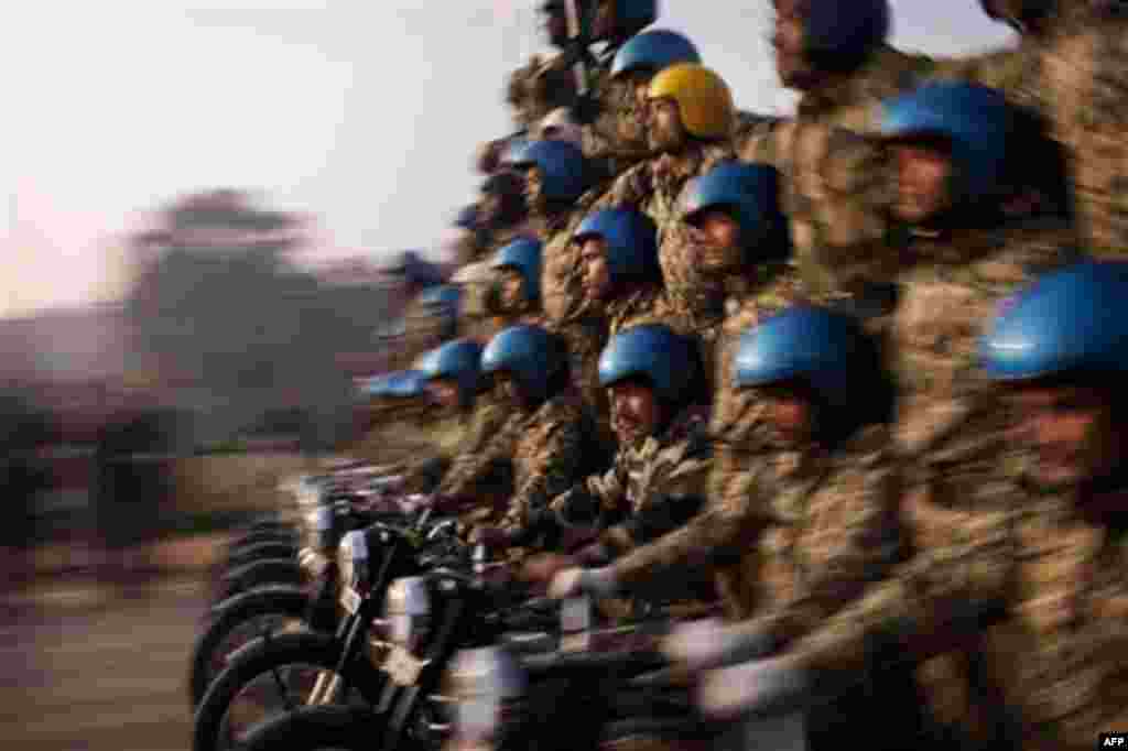 Indian soldiers train on stunt motorcycles in preparation for an upcoming Republic Day parade in New Delhi, India, Friday, Jan. 13, 2012. India marks Republic Day on Jan. 26. (AP Photo/Kevin Frayer)