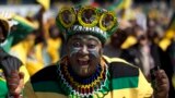 A woman sporting headgear with portraits of South African president Jacob Zuma attends a final African National Congress (ANC) election rally in Soweto, on the edge of Johannesburg.