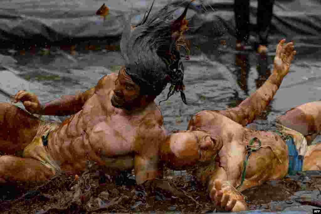 Competitors take part in the 8th annual World Gravy Wrestling Championships at the Rose n Bowl Pub in Bacup, north west England. 