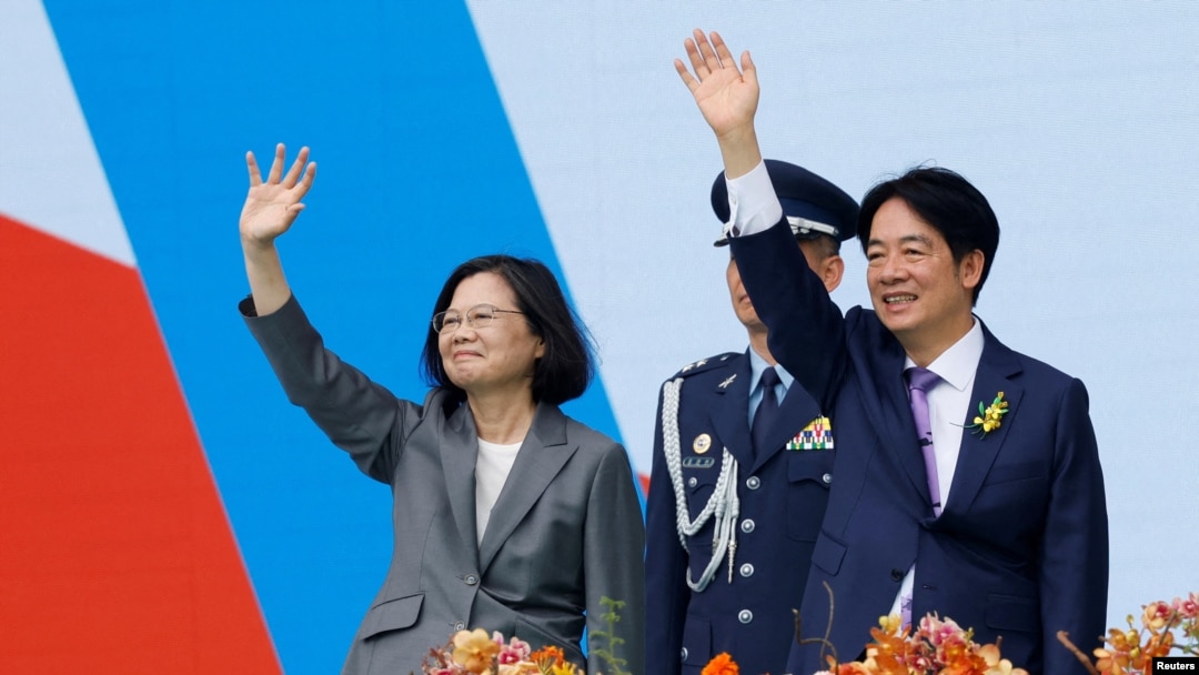 Taiwan's former President Tsai Ing-wen and new President Lai Ching-te wave to people during the inauguration ceremony outside the Presidential office building in Taipei, Taiwan May 20, 2024. 