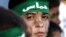 FILE - A Palestinian boy wears a headband with the logo of Hamas during a rally of the miltant Islamic group in the West Bank town of Bethlehem.