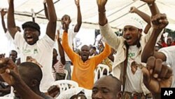 Supporters of opposition leader Alassane Ouattara, make their feelings known, as they sing at an event at a hotel in Abidjan, Ivory Coast, 30 Dec 2010