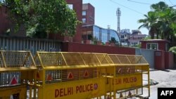 FILE - Police barricades are seen in front of the gate of the Twitter India's office at Crescent building in New Delhi on May 25, 2021, as police served a notice at Twitter's offices over flagged governments tweets as "manipulated media" a day before.