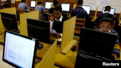 FILE - Students use computers to study at Elswood Secondary School in Cape Town, Nov. 7, 2013. 