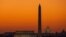The orange sky of sunrise is captured behind the skyline of Washington on the first day back to work for the U.S. Congress after their summer recess.