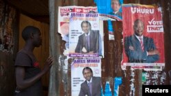 A boy enters an house with various campaign posters at the Kangemi slum in Kenya's capital Nairobi, Feb. 28, 2013. 