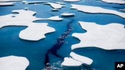 FILE - Sea ice breaks apart at the Northwest Passage, in the Canadian Arctic Archipelago, July 21, 2017.