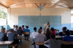 Franz Merisier teaches a Spanish class at the College Saint Pierre-Eglise Episcopale D'Haiti as schools and businesses tentatively reopen their doors after anti-government protests begin to wane, in Port-au-Prince, Haiti, Dec. 3, 2019.