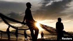 Fishermen pull nets at Gampong Jawa beach, ahead of the 20th anniversary of the Indian Ocean tsunami, in Banda Aceh, Indonesia, on Dec. 25, 2024.