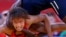 Senegal's Isabelle Sambou (in blue) fights with Tunisia's Maroi Mezien on the repechage of the Women's 48Kg Greco-Roman wrestling. 