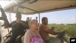 FILE —In this still image taken from video, Hamas' militants transport Yaffa Adar, 85, an Israeli civilian kidnapped from Nir Oz, into Gaza strip in a golf cart, in an unspecified location between Israel and Gaza, Oct. 7, 2023.