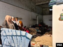 FILE - Refugees take shelter in a gas station in the Turkish country side, saying they want to cross the closed Greek border and do not want to be taken to Istanbul, were they could be homeless and potentially exposed to coronavirus, March 18, 2020.