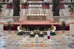 FILE - Pope Francis reads his "Urbi et Orbi" ("To the City and the World") message in St. Peter's Basilica with no public participation due to an outbreak of the coronavirus disease (COVID-19) on Easter Sunday at the Vatican.