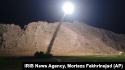 FILE - A missile is fired from city of Kermanshah, in western Iran, targeting the Islamic State group in Syria, June 19, 2017. Syrian government and allied troops have inserted themselves into the battle against IS militants by capturing key areas on the flanks of the coalition-led battle to seize Raqqa. 