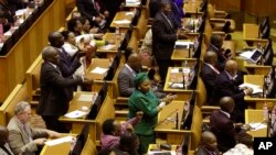 Members of the ruling African National Congress applaud as the results are read of a no-confidence vote by MP's in parliament in Cape Town South Africa, Aug. 8, 2017.