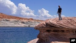 Bill Schneider stands near Antelope Point's public launch ramp off Lake Powell, which closed to houseboats as early as October of 2020, July 31, 2021, near Page, Arizona.