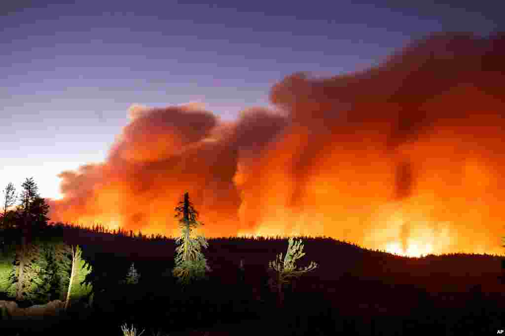 Seen in a long camera exposure, the Caldor Fire burns, Aug. 29, 2021, in Eldorado National Forest, California.