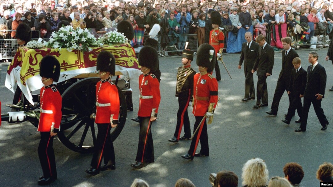 FILE - Guardsmen escort the coffin of Diana, Princess of Wales draped in the Royal Standard, as the cortege passes through crowds gathered along Whitehall. Walking behind them are the Duke of Edinburgh, Prince William, the Earl of Spencer, Prince Harry and Princ
