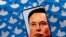 FILE PHOTO: Illustration shows Elon Musk image on smartphone and printed Twitter logos