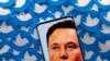 FILE PHOTO: Illustration shows Elon Musk image on smartphone and printed Twitter logos