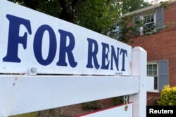 FILE - A for-rent sign sits in front of a home in Arlington, Va., June 8, 2021.