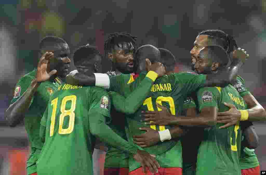 Cameroon's Karl Toko-Ekambi, center, celebrates with teammates after scoring his side's first goal against Comoros.