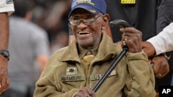 FILE - Richard Overton leaves the court after a special presentation honoring him as the oldest living American war veteran, March 23, 2017, at an NBA basketball game. 
