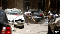 FILE - Volunteers clear rubble in Beirut, Aug. 14, 2020. Two politicians wanted for questioning in the blast investigation filed a new complaint against the lead investigator.