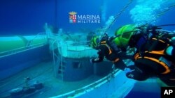 The migrant ship that sank off Sicily last year with an estimated 700 people onboard is being recovered by the Italian Navy, June 28, 2016. The navy says it's raised the boat toward the surface from a depth of more than 1200 feet. (Italian Navy photo))