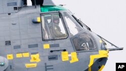 FILE - Britain's Prince William is seen at the controls of a helicopter in Dalvay-by-the-Sea on Prince Edward Island, during the Royal Tour of Canada, July 4, 2011.