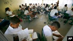 FILE - Students of the Primary School study in their classroom in Acapulco, Mexico, April 9, 2013.