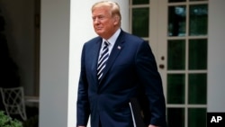 FILE - President Donald Trump arrives for a bill signing ceremony for the "VA Mission Act" in the Rose Garden of the White House, June 6, 2018, in Washington.