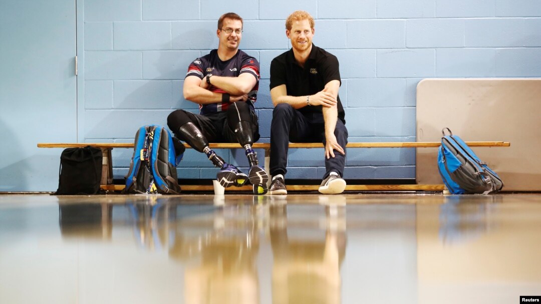 Britain's Prince Harry sits with an athlete at the Toronto Pan Am Sports Centre ahead of the Invictus Games in Toronto, Sept. 22, 2017. 
