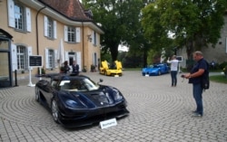 FILE - A Koenigsegg One:1, a Ferrari LaFerrari and a Bugatti Veyron EB 16.4 Coupe, part of a collection of luxury cars owned by Teodorin Obiang, the son of the Eq. Guinea president, confiscated the Swiss prosecutor in Geneva, Sept. 27, 2019.