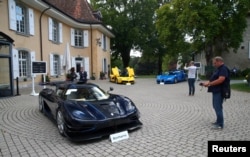 FILE - A Koenigsegg One:1, a Ferrari LaFerrari and a Bugatti Veyron EB 16.4 Coupe, part of a collection of luxury cars owned by Teodorin Obiang, the son of the Eq. Guinea president, confiscated the Swiss prosecutor in Geneva, Sept. 27, 2019.