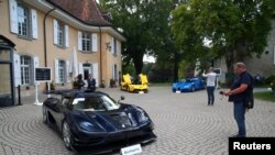 A Koenigsegg One:1 (2015), a Ferrari LaFerrari (2015) and a Bugatti Veyron EB 16.4 Coupe (2010), part of a collection of luxury cars owned by Teodoro Obiang, the son of the Eq. Guinea president, confiscated the Swis prosecutor in Geneva, Sept. 27, 2019. 