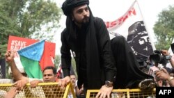 Mazdak Dilshad Baloch, son of author-activist Naela Qadri Baloch and filmmaker Mir Ghulam Mustafa Raisaini, climbs a police barricade during a protest against Pakistan's ongoing human right violation in Balochistan, in New Delhi on September 29, 2016.