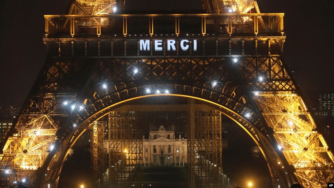 Un cartel luminoso en la Torre Eiffel que despliega la palabra "Merci" (Gracias, en francés).