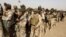 Iraqi security forces wait for vehicles traveling to Mosul to fight against militants of Islamic State at an Iraqi army base in Camp Taji in Baghdad, Feb. 21, 2016.